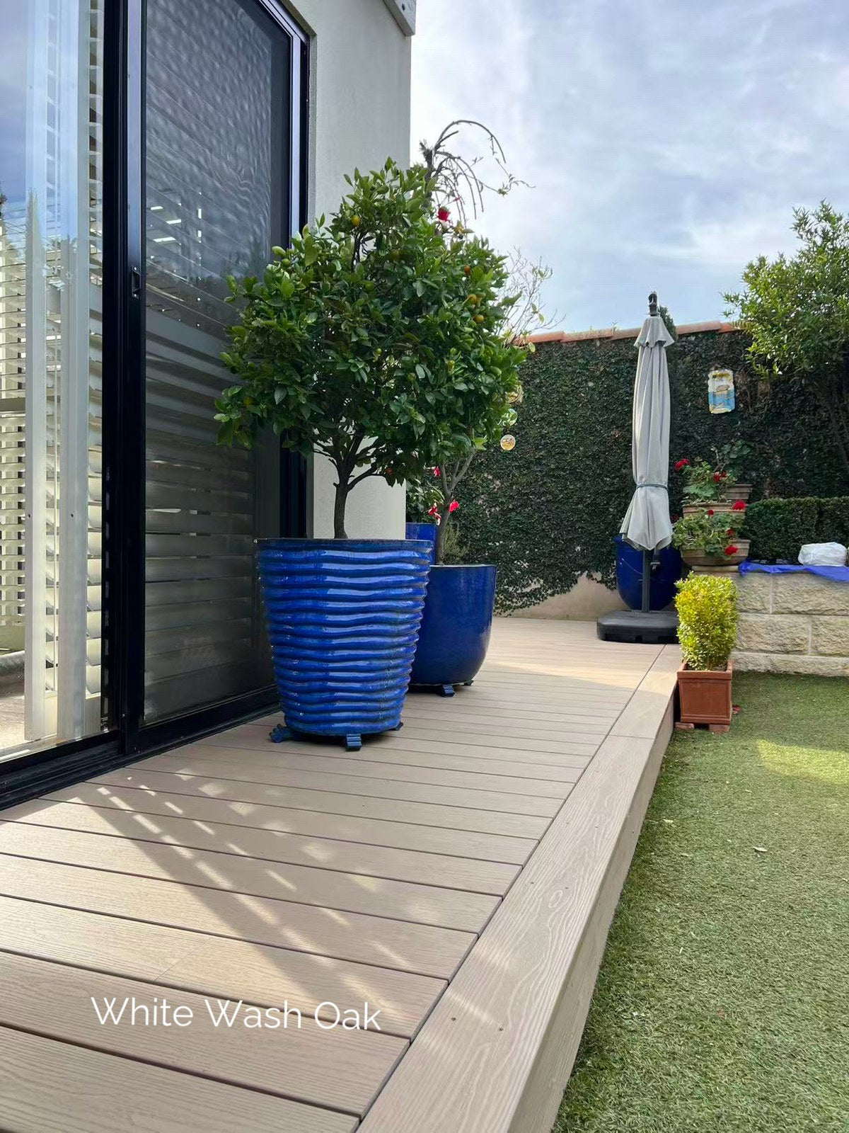 EVERTEX Pioneer White Wash Oak PVC decking on a courtyard deck